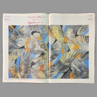painting of bird wings with blue and ochre colors on a magazine