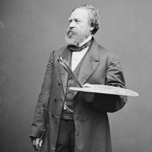 Black and White photograph of Constantino Brumidi artist of the Capitol holding palette and brushes wearing a suit.