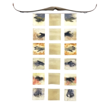 Decorative wall hanging with a curved bow above a grid of 15 small fabric squares in beige and watercolor patterns.