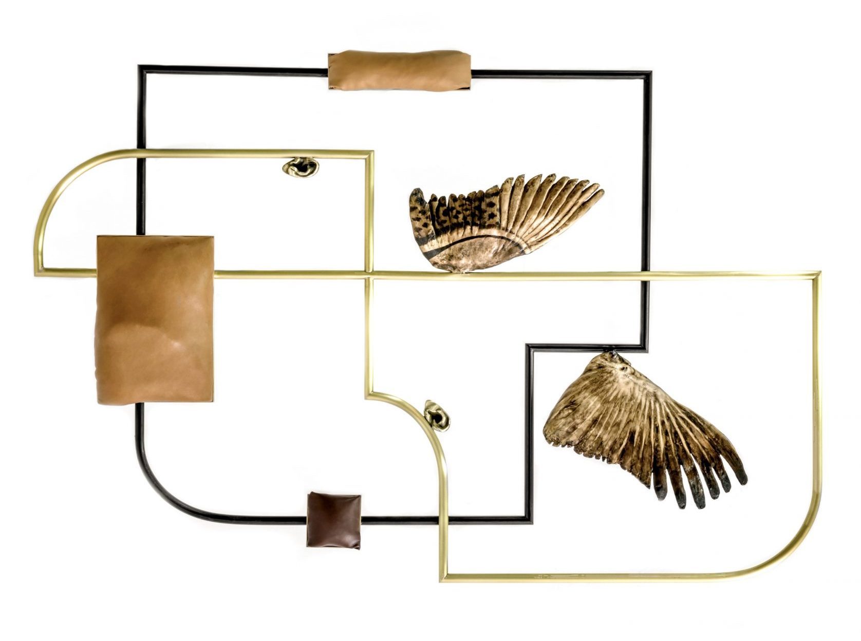 A geometric wall sculpture with organic line and curvature, bronze leather and wing elements.