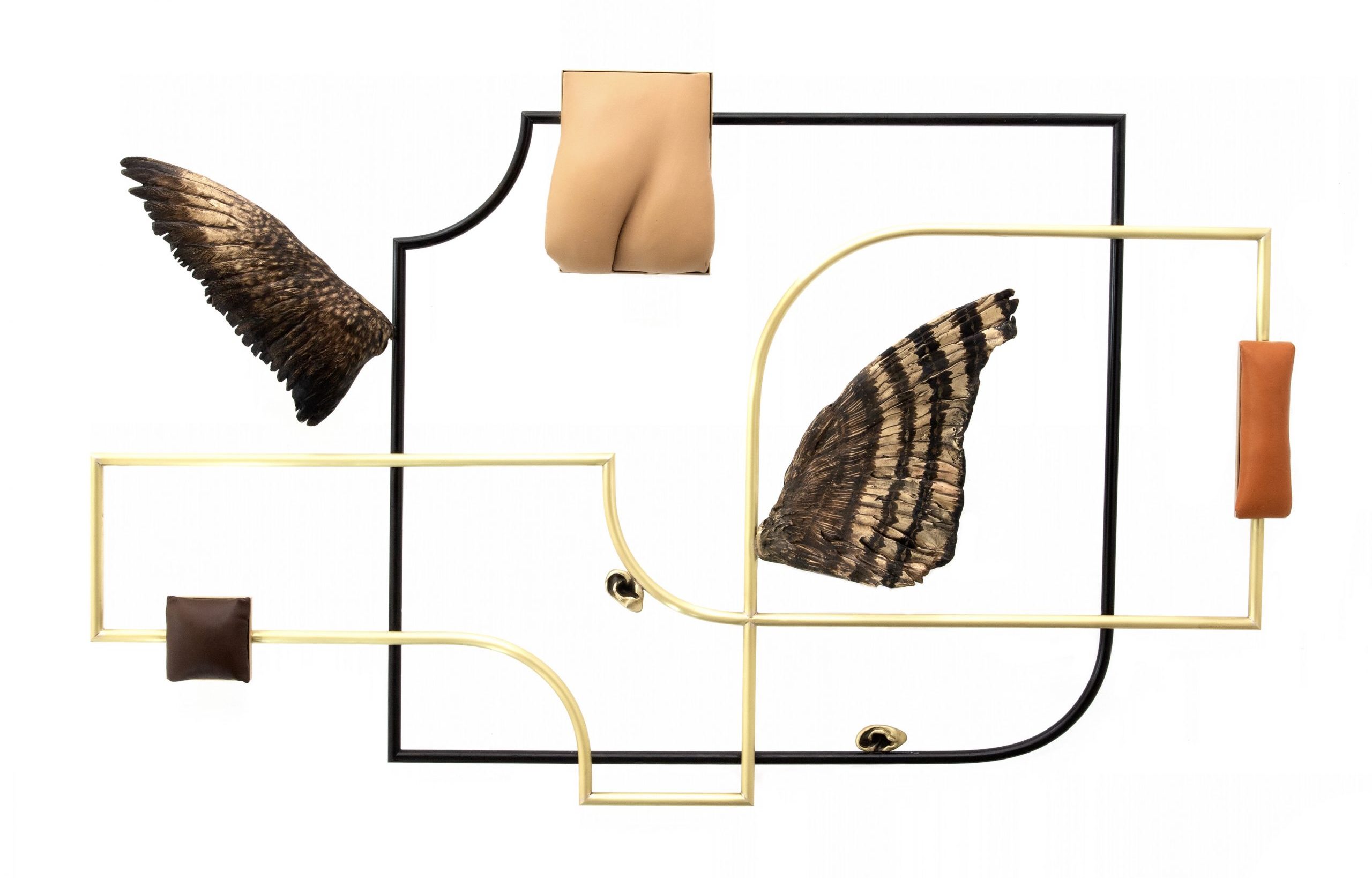 A geometric wall sculpture with organic line and curvature, bronze leather and wing elements.
