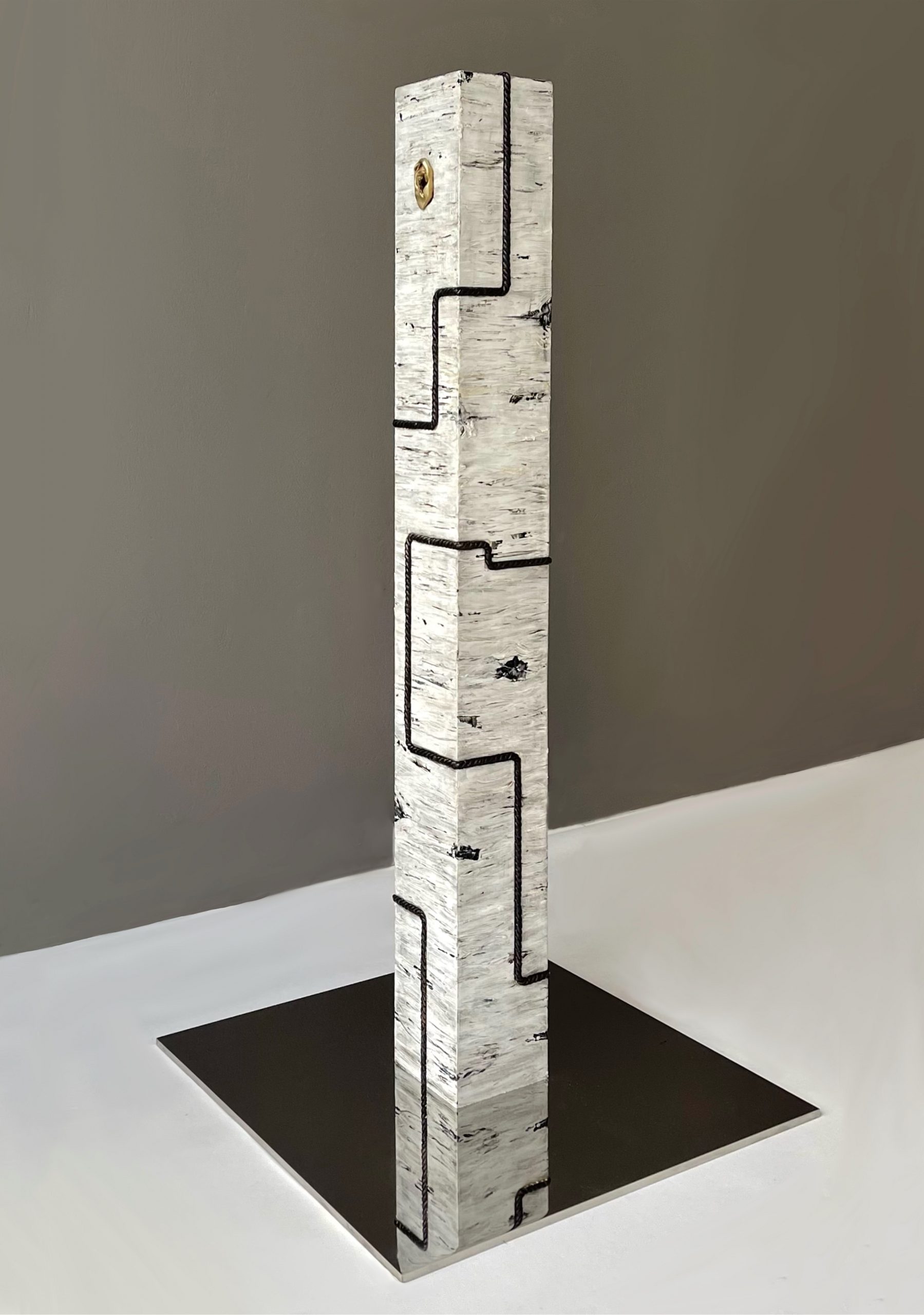 Vertical totem like sculpture with geometric bronze cord and ears on the sides