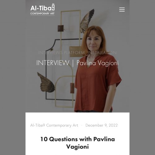 Pavlina Vagioni in front of a wall sculpture and Al-Tiba9 logo
